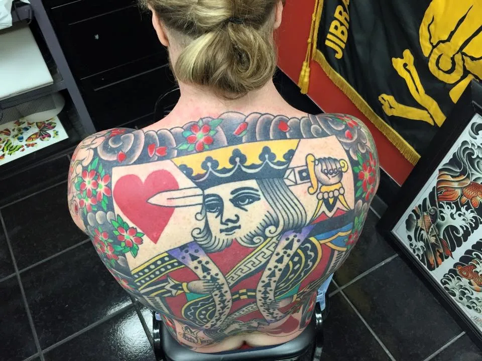 Upper-back view of a King of Hearts playing card back piece, the crown and sword detail centred on the shoulders