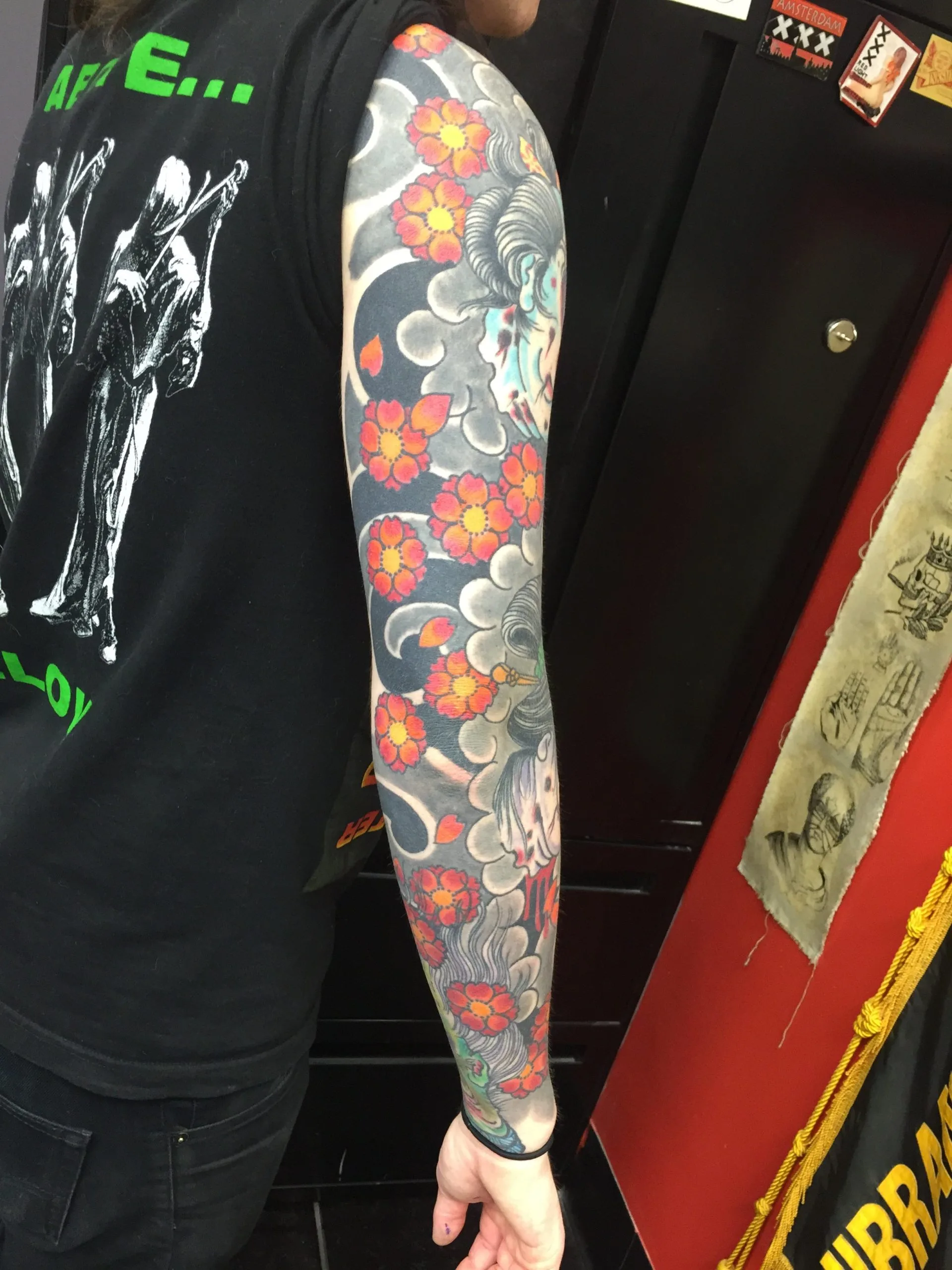 Outer view of a colour Japanese full sleeve dense with orange and red cherry blossoms over grey clouds