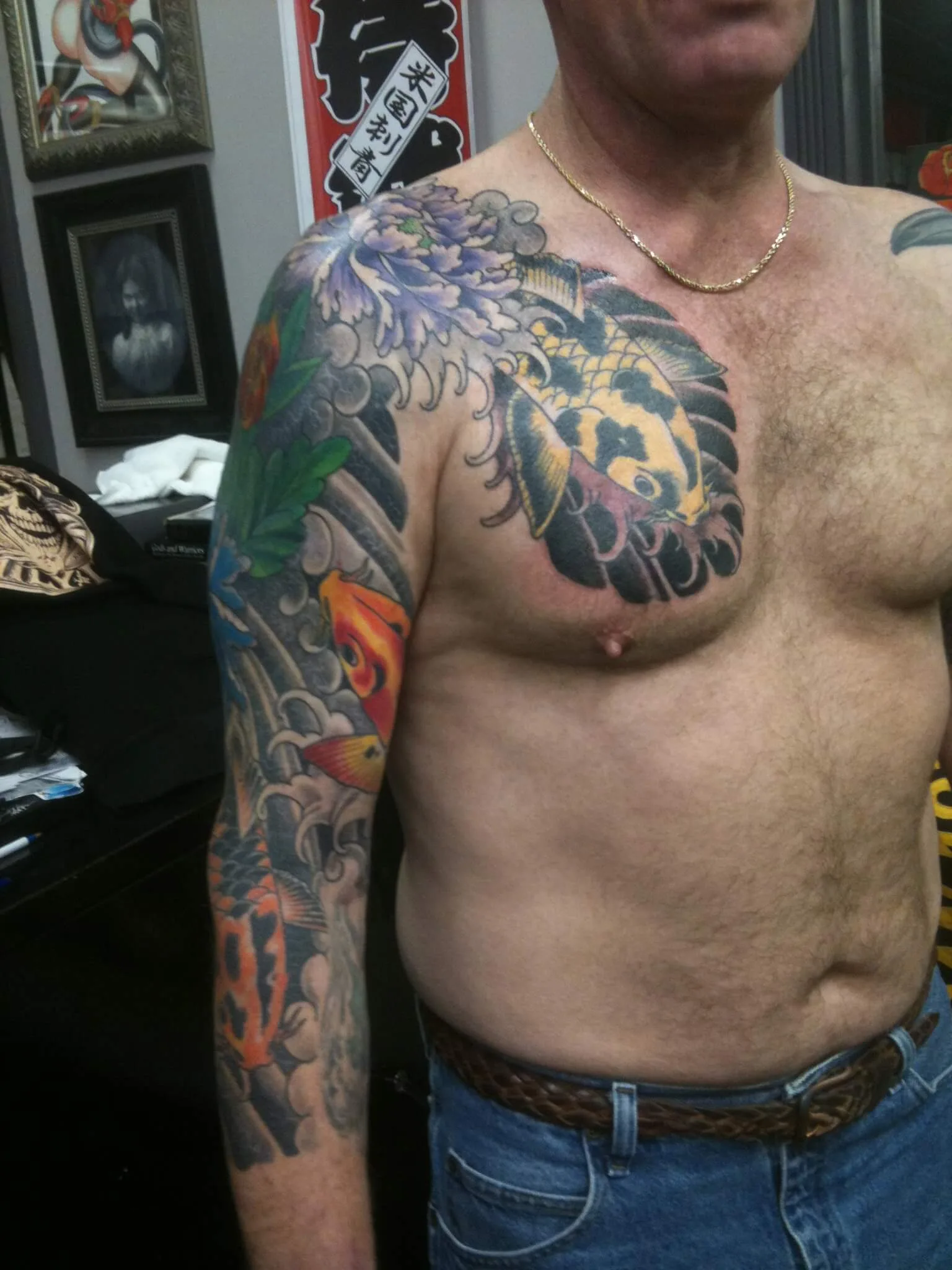 Colour shoulder and chest piece with a red koi fish, a purple chrysanthemum, and a black feathered design
