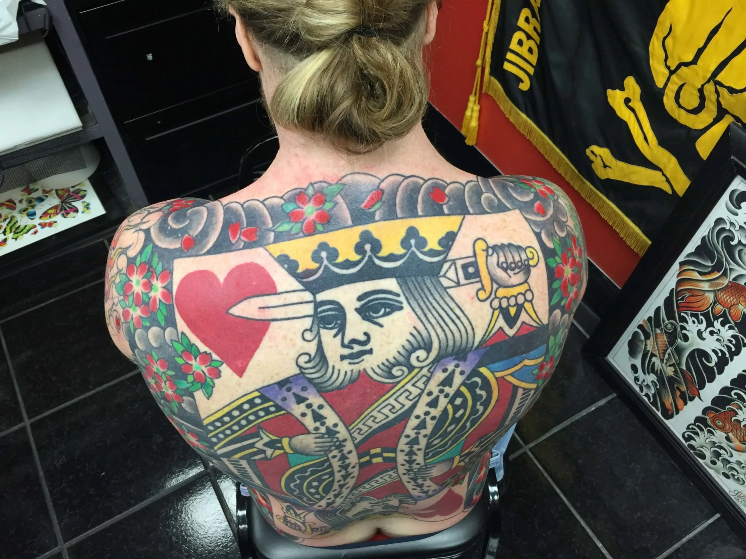 colour back piece with a King of Hearts playing card, a red heart, and gold ornamental border details