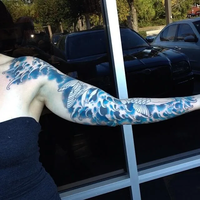 Blue and white full-arm sleeve featuring Japanese wave patterns extending to the hand