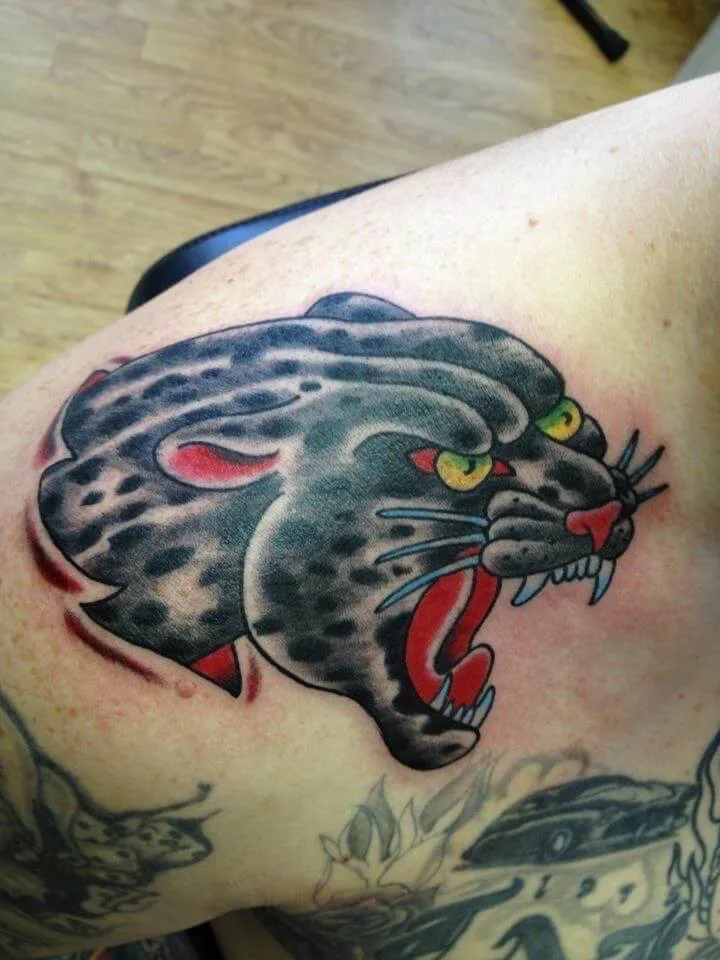 colour shoulder piece with a black panther head, yellow eyes, and a red open mouth