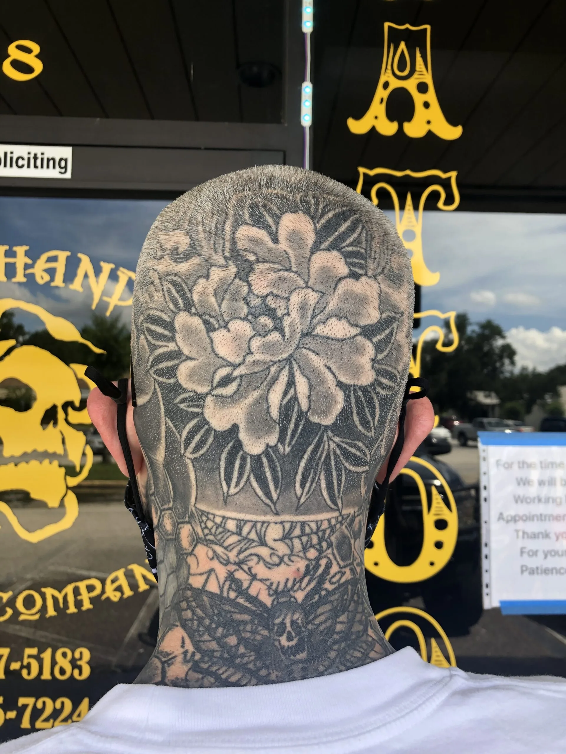Grey peony with leaves on the back of the head, spider web design continuing onto the neck