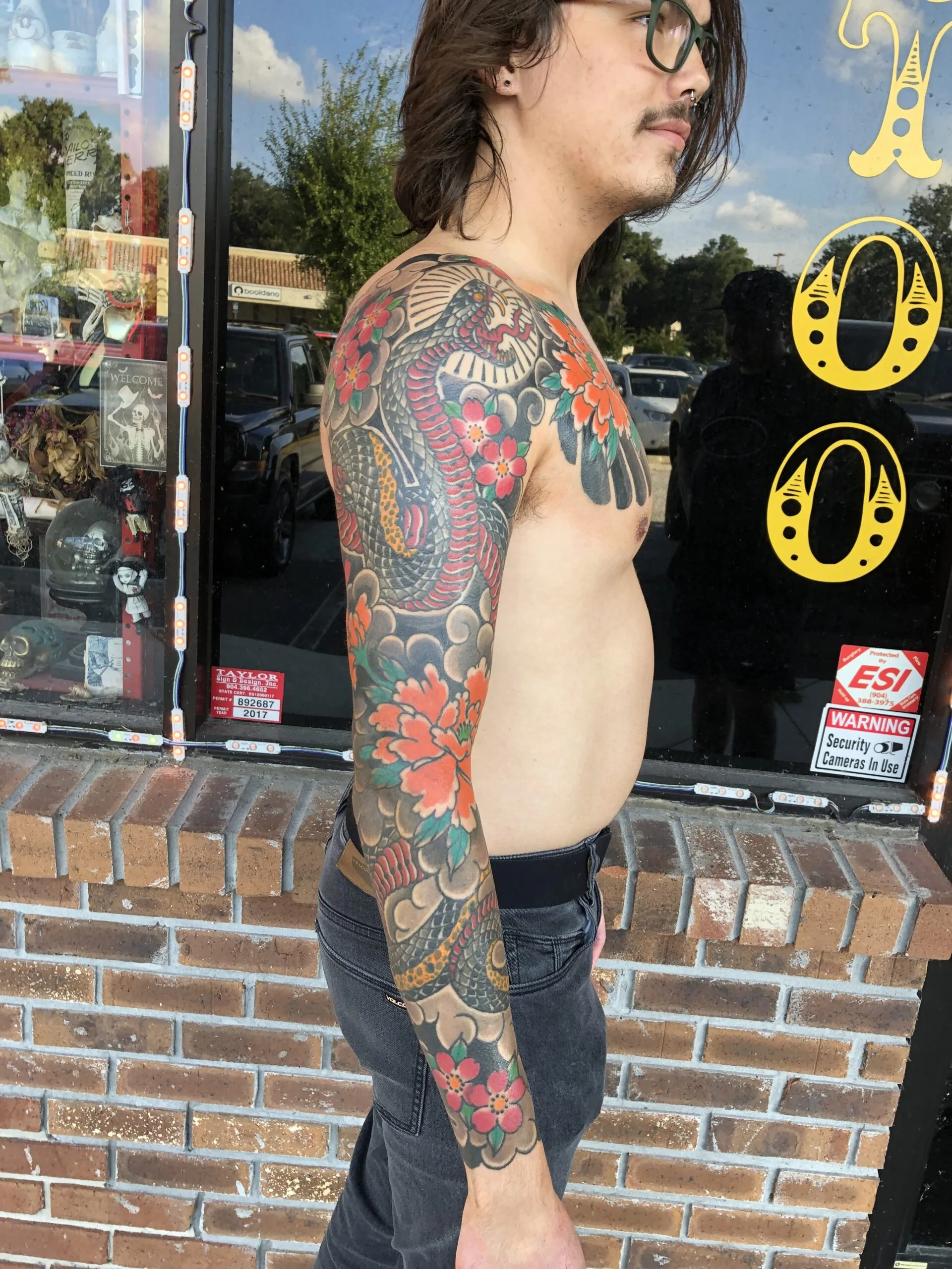 colour full sleeve blending black tribal patterning with dragon scale texture, a chrysanthemum flower, and grey wave clouds