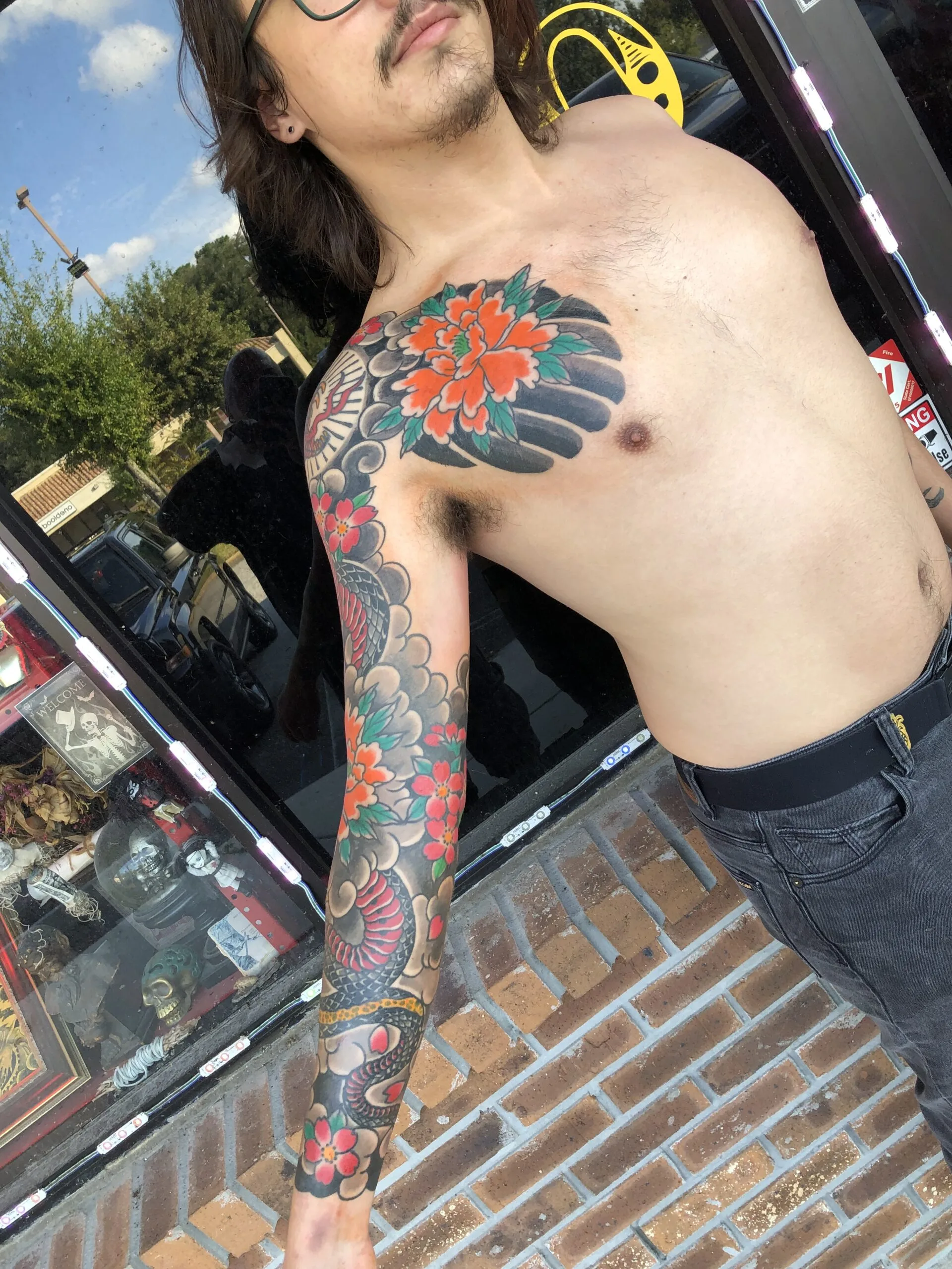 Color shoulder and full-arm sleeve featuring a large orange peony blending into patterned floral work down the arm