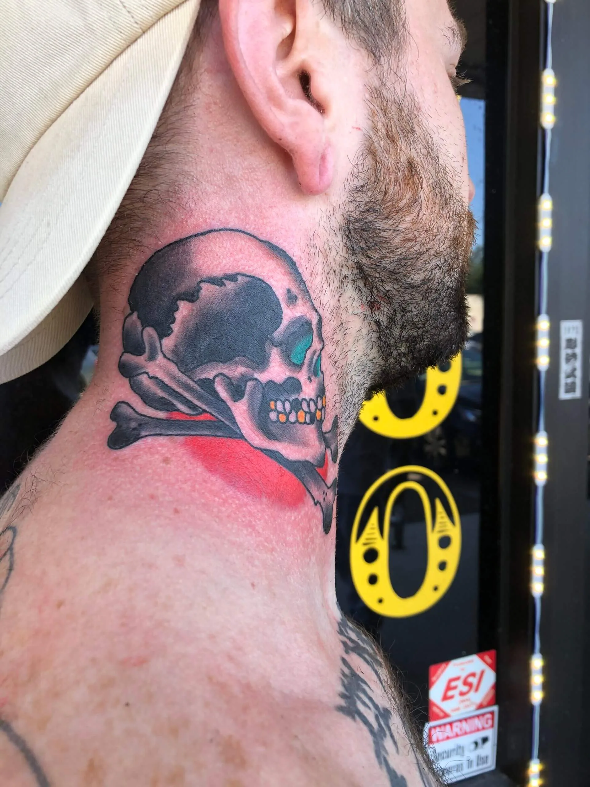 neck piece with a skull and crossbones, a green-tinted eye socket, and red shading behind